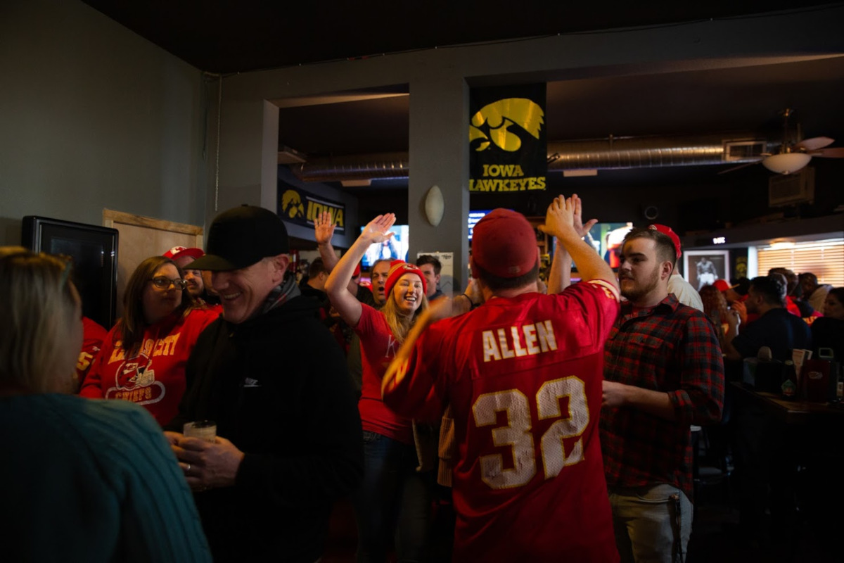 Interior, guests watching a game